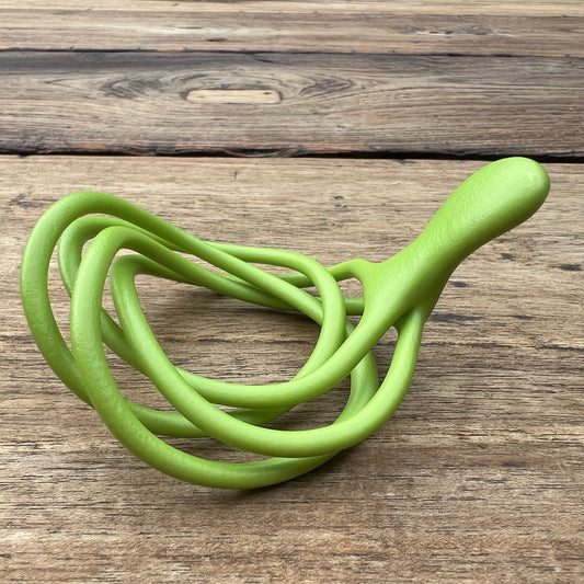 A polished green Velv'Or JNamo intimate massager featuring a unique, flexible looped ergonomic design with a smooth perineum part