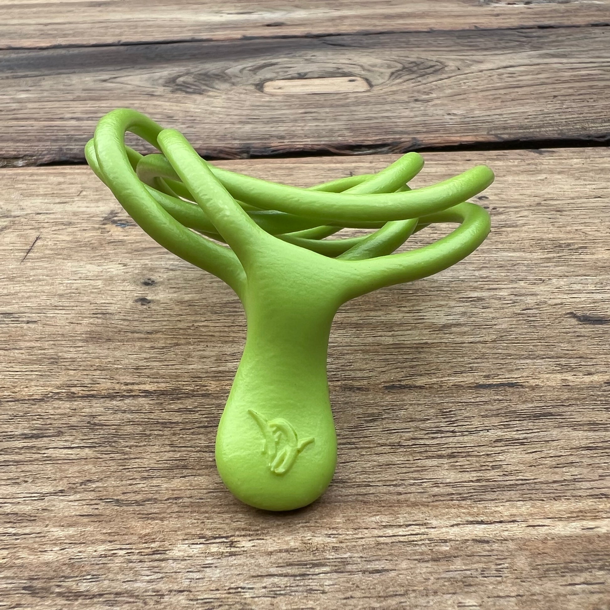 A polished green Velv'Or JNamo intimate massager featuring a unique, flexible looped ergonomic design with a smooth perineum part